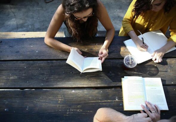 a few people studying at a table